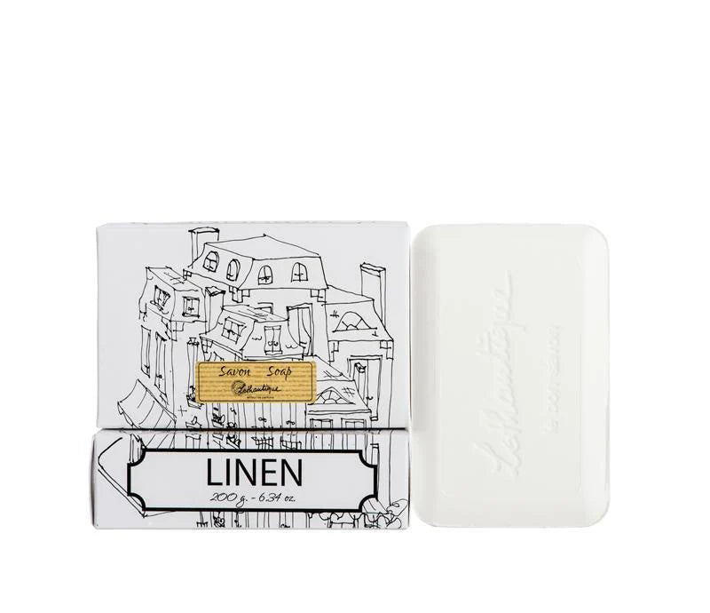 Bar of soap with packaging labeled 'Linen' on a white background