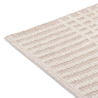 Close-up of the high-low pile and tidy bound edge on the cream and beige Beckett textured stripe rug.