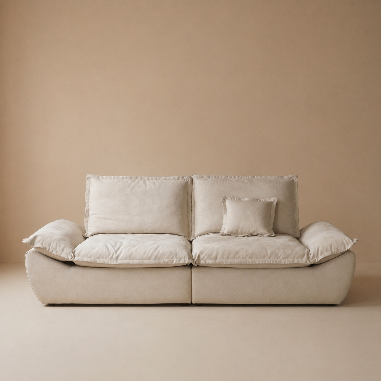Front studio shot of the sailing-shaped modular loveseat in cream showcasing the flared base design.
