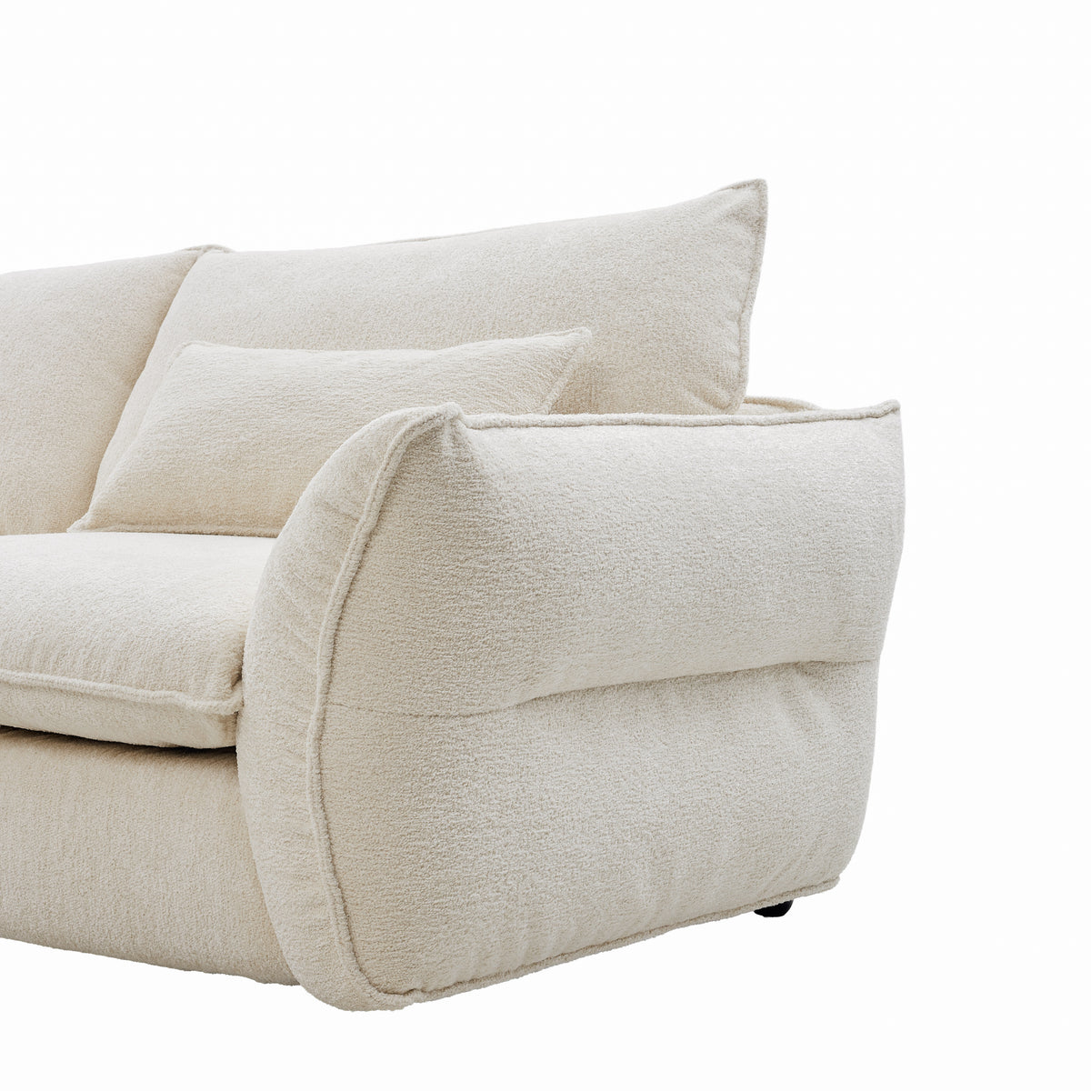 Close-up of Bella Boucle Sofa showing the armrest, back cushion, and matching throw pillow against a plain white background.