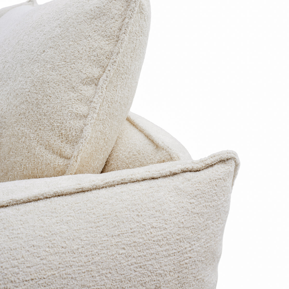 Close-up of Bella Boucle Sofa cushion showing the plush looped weave and stitched details against a white background.