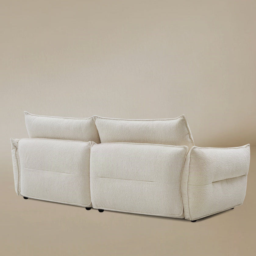 Bella Boucle Sofa in a cream boucle fabric, shown the back in angle view.