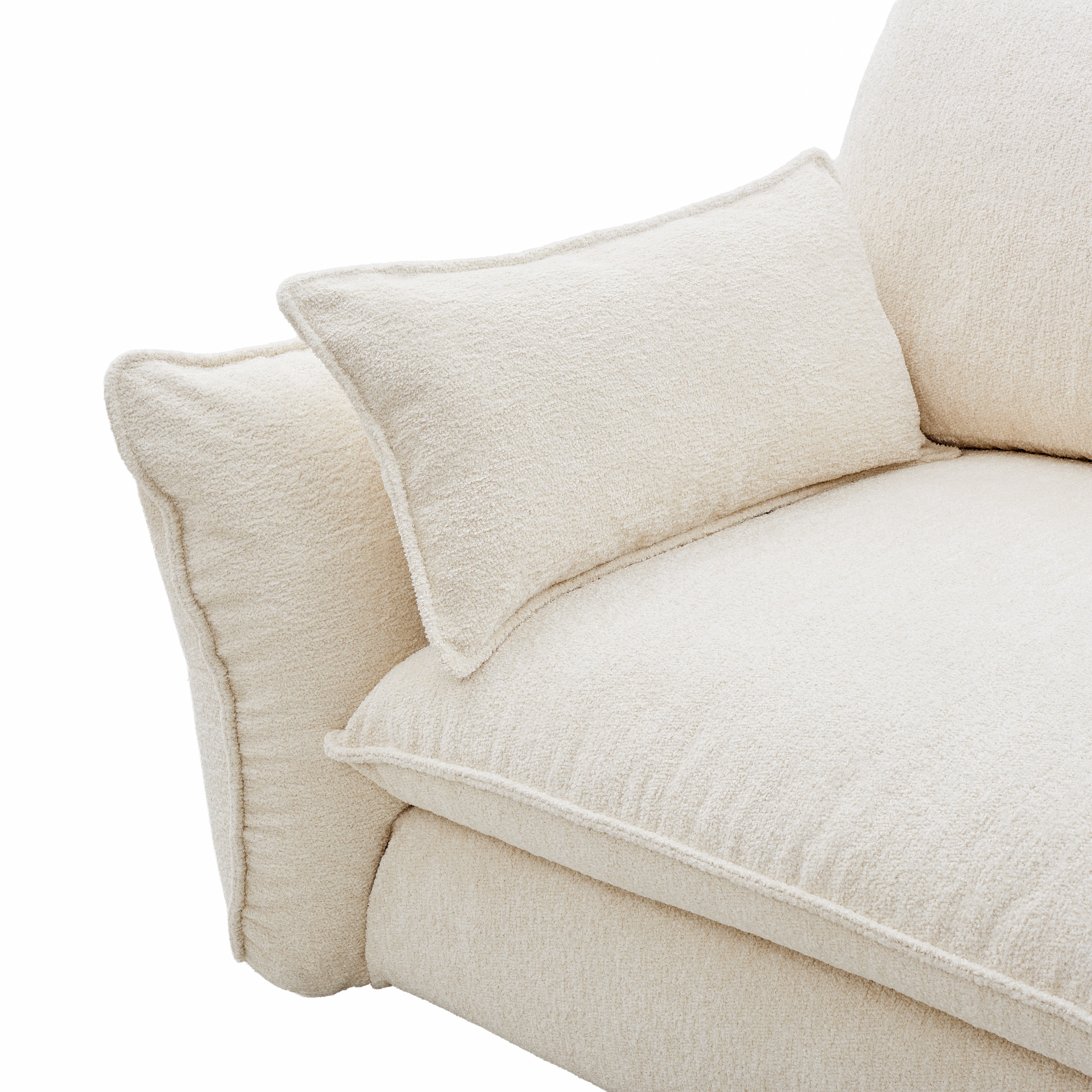 Close-up of Bella Boucle Sofa corner with matching throw pillows on a white background.