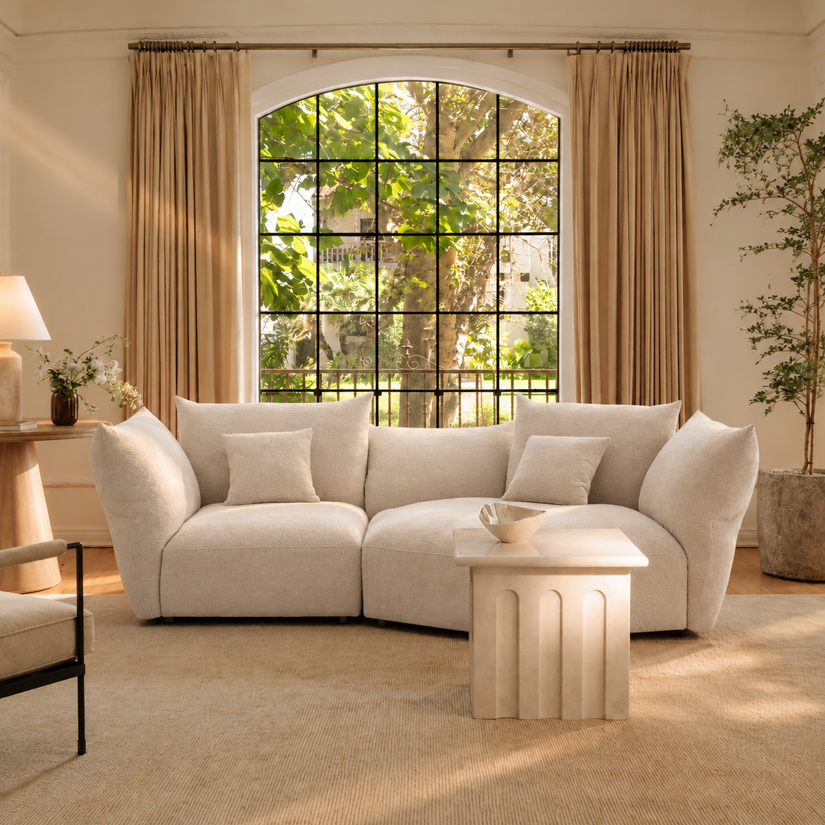 Blooming Embrace Modular Sofa, Large Chaise with One Seater, in Pearl White chenille in a sunlit living room with an arched window, neutral curtains and a fluted stone coffee table