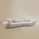 [Pearl White / Blooming Large Chaise with Two Seater (134"-152")] Angled view of the Blooming Embrace Modular Sofa, Large Chaise with Two Seater, in Pearl White chenille on a beige studio background