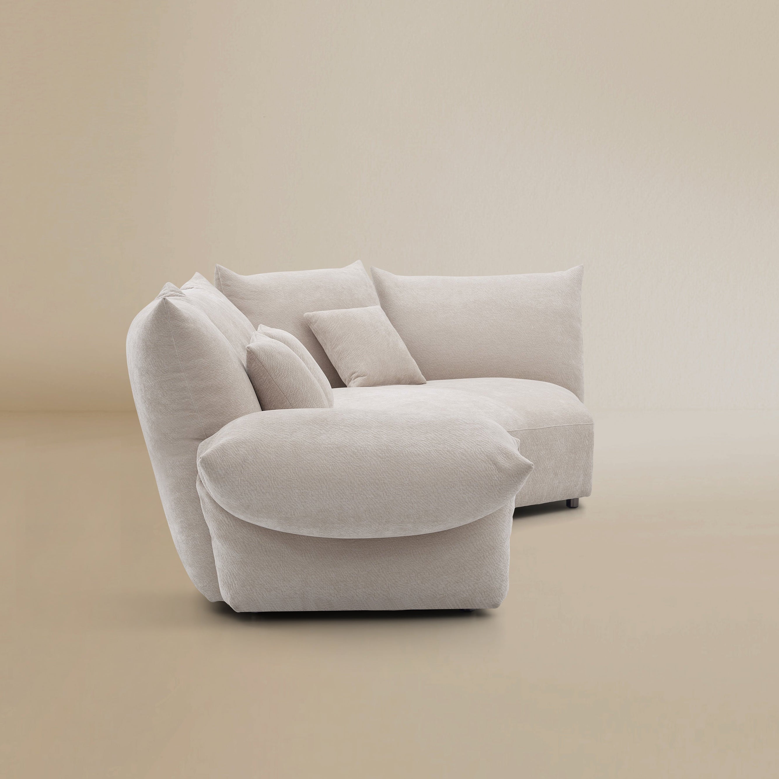 Side profile of the Blooming Embrace Modular Sofa in pearl chenille fabric on beige studio background