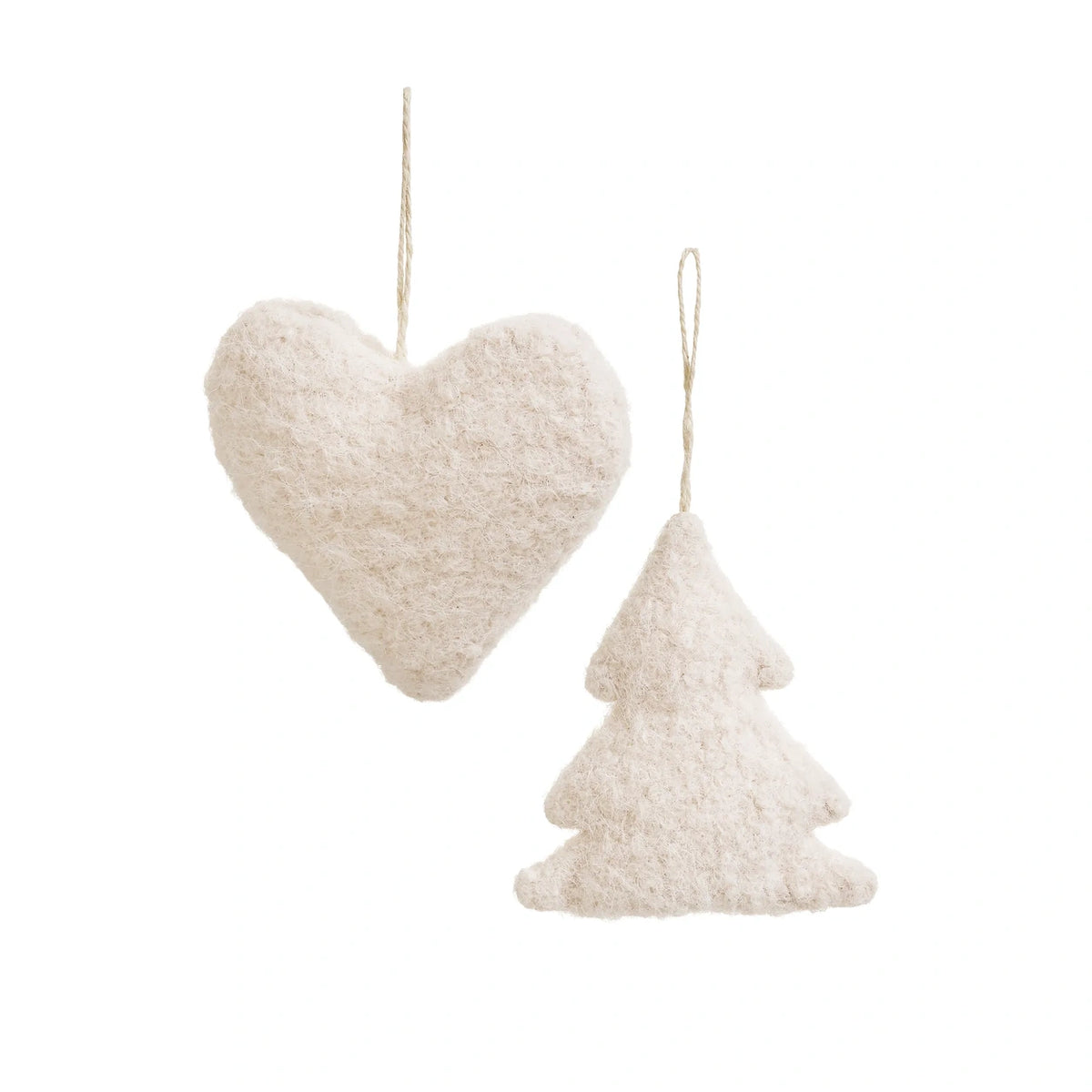Two textured off-white holiday ornaments, one in the shape of a heart and one in the shape of a pine tree, both hanging from thin natural twine loops against a solid white background.