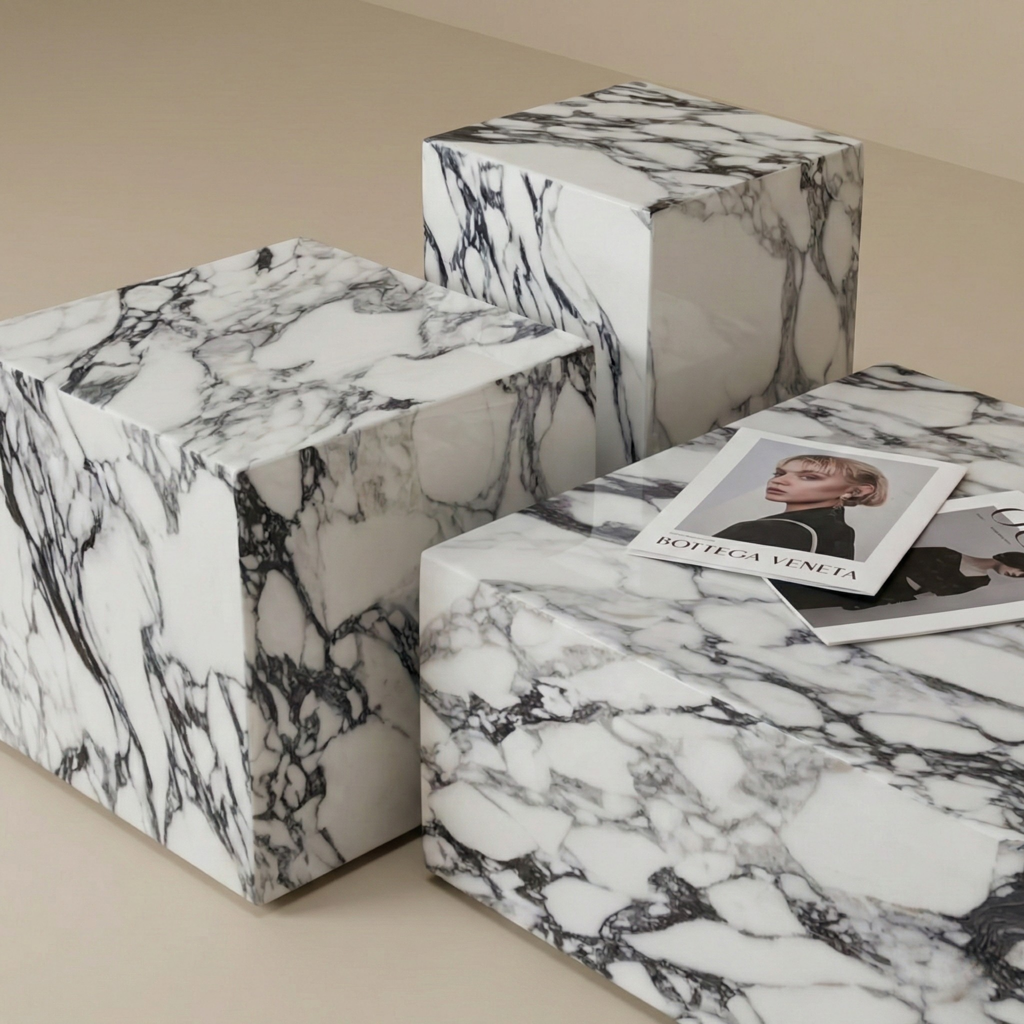 Angled view of a geometric marble-patterned plinth side table set showing block construction and varying heights.