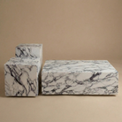Three marble-patterned boxes on a beige background