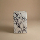 Marble-patterned cube on a beige background