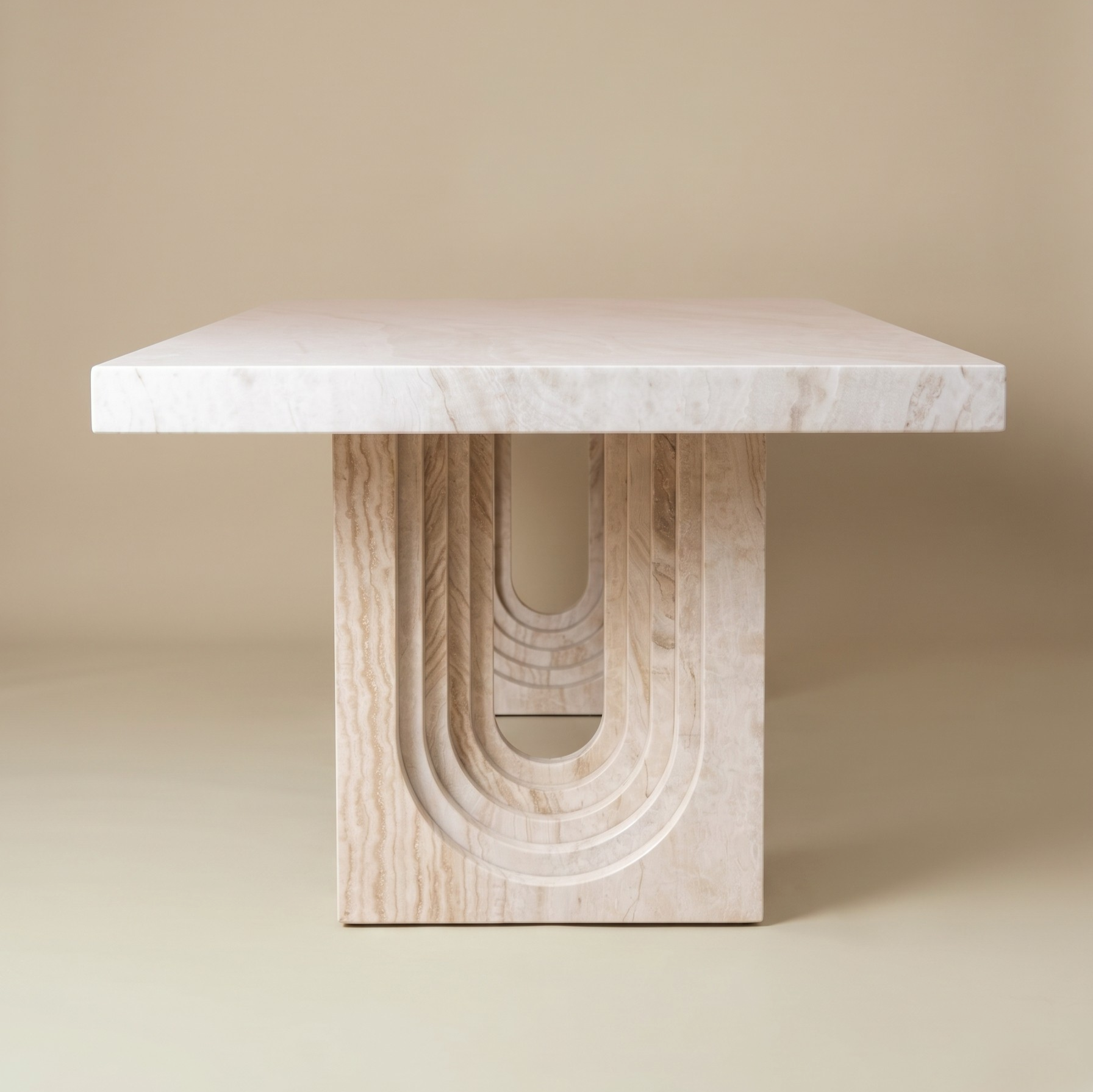 Side view of a traverine dining table on a beige background.