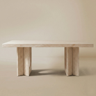Natural travertine dining table on a beige background.