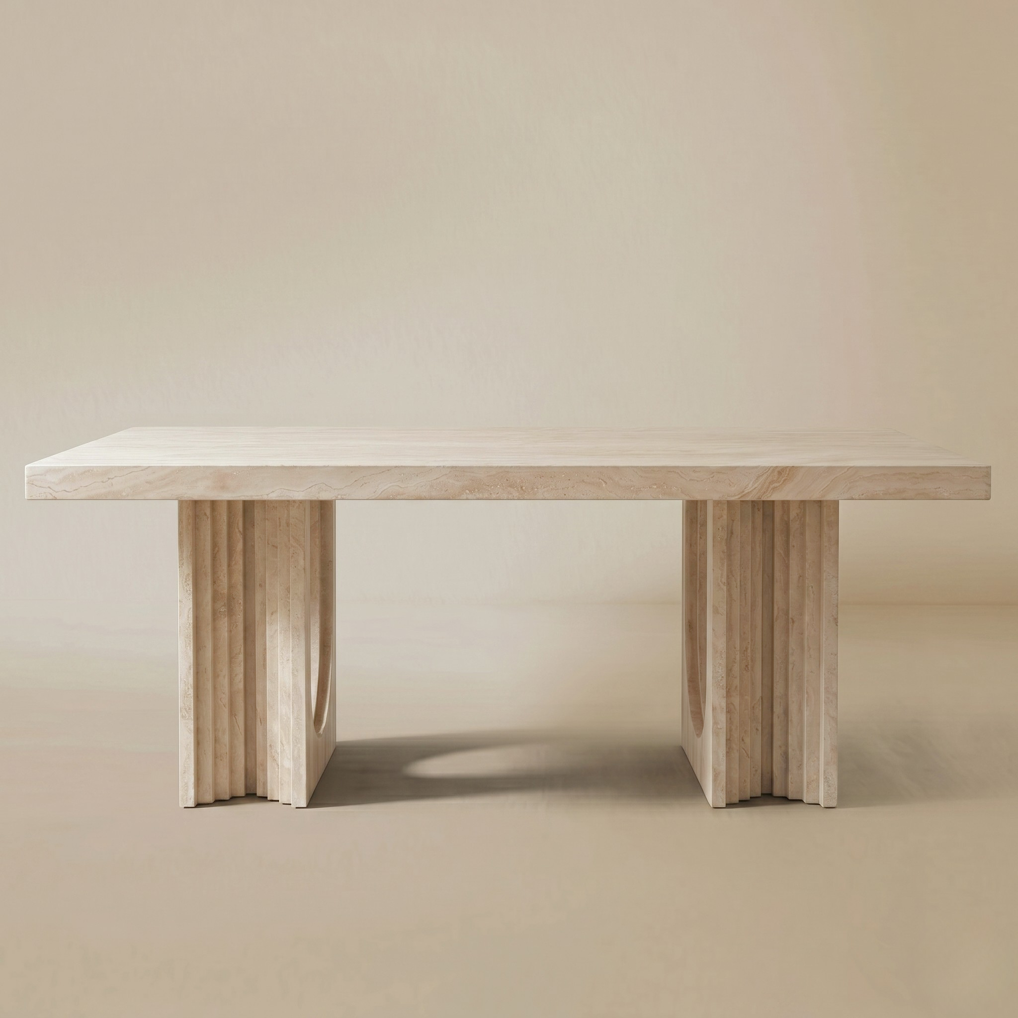 Natural travertine dining table on a beige background.