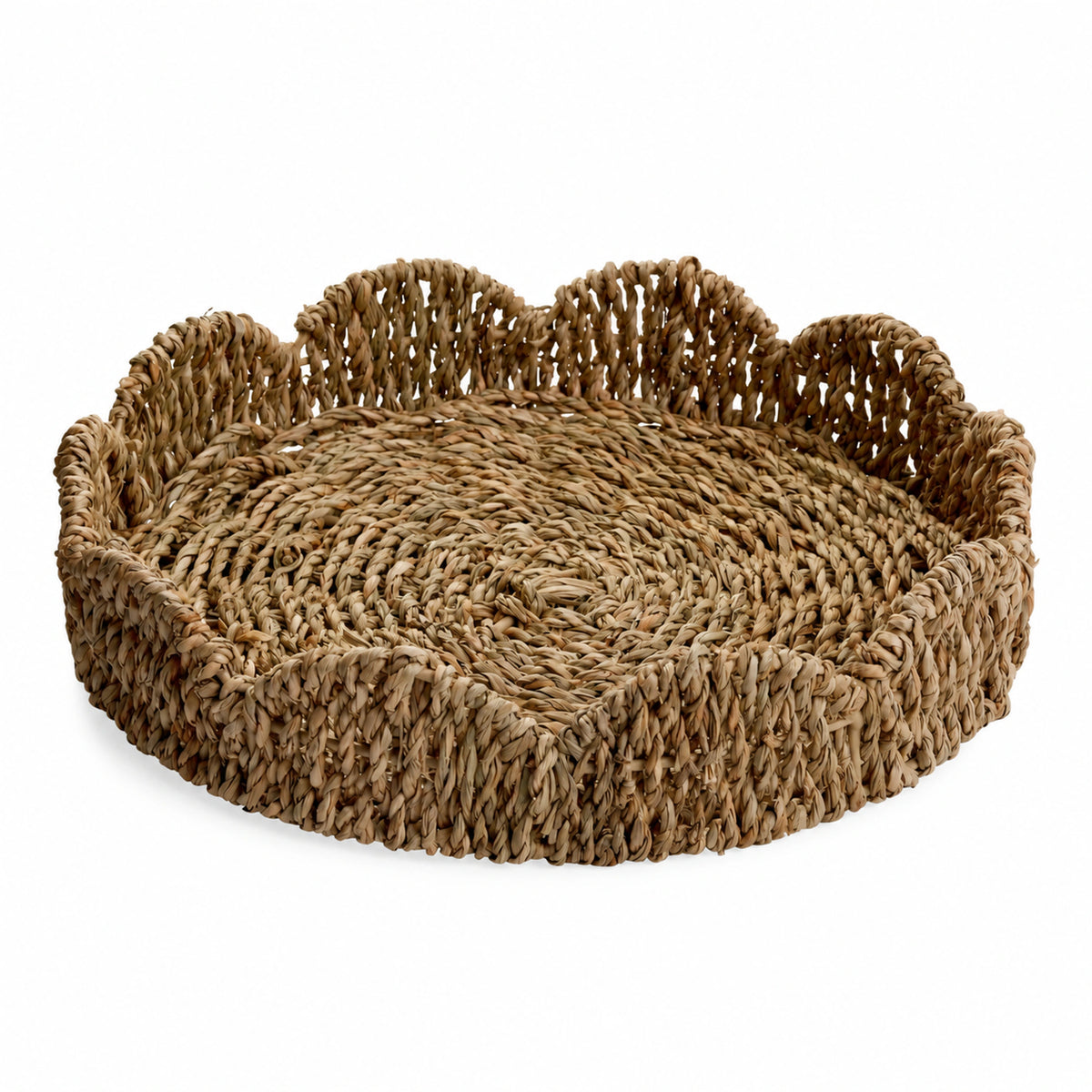 Cala natural handwoven seagrass tray with a raised scalloped rim on a white background.