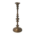 Caldria antique brass-finished candle holder showing its sculpted stem, flared candle cup, and round base.