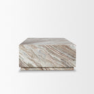 Side-angle view of the Calista Marble Plinth Coffee Table showing its monolithic block silhouette and recessed base.