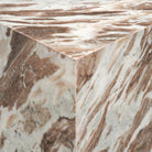 Close-up corner view of the Calista Marble Plinth Side Table showing the polished marble edge and continuous natural veining.
