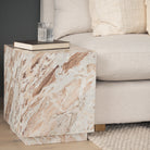 Calista Marble Plinth Side Table styled beside a neutral sofa in a contemporary living room.