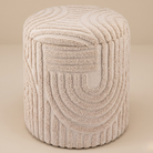Textured beige ottoman on a beige background