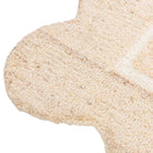 Close-up of the Camille Hand-Tufted Wool Rug showing its hand-tufted loop texture and scalloped cream edge.