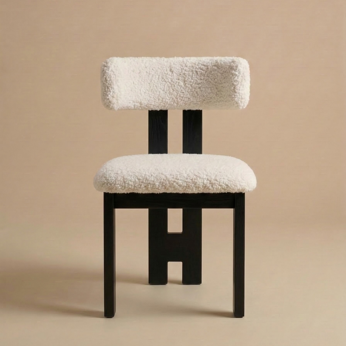 Front view of the modern dining chair featuring a striking black ash wood frame with a unique central back leg and a textured white bouclé seat featuring...