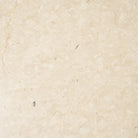 Natural cream Botticino marble colour and veining of the Caspia dining table