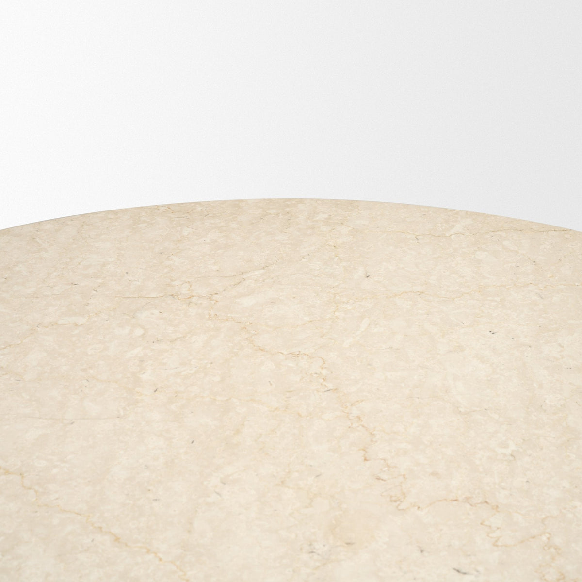 Close-up of the Caspia dining table polished Botticino marble surface