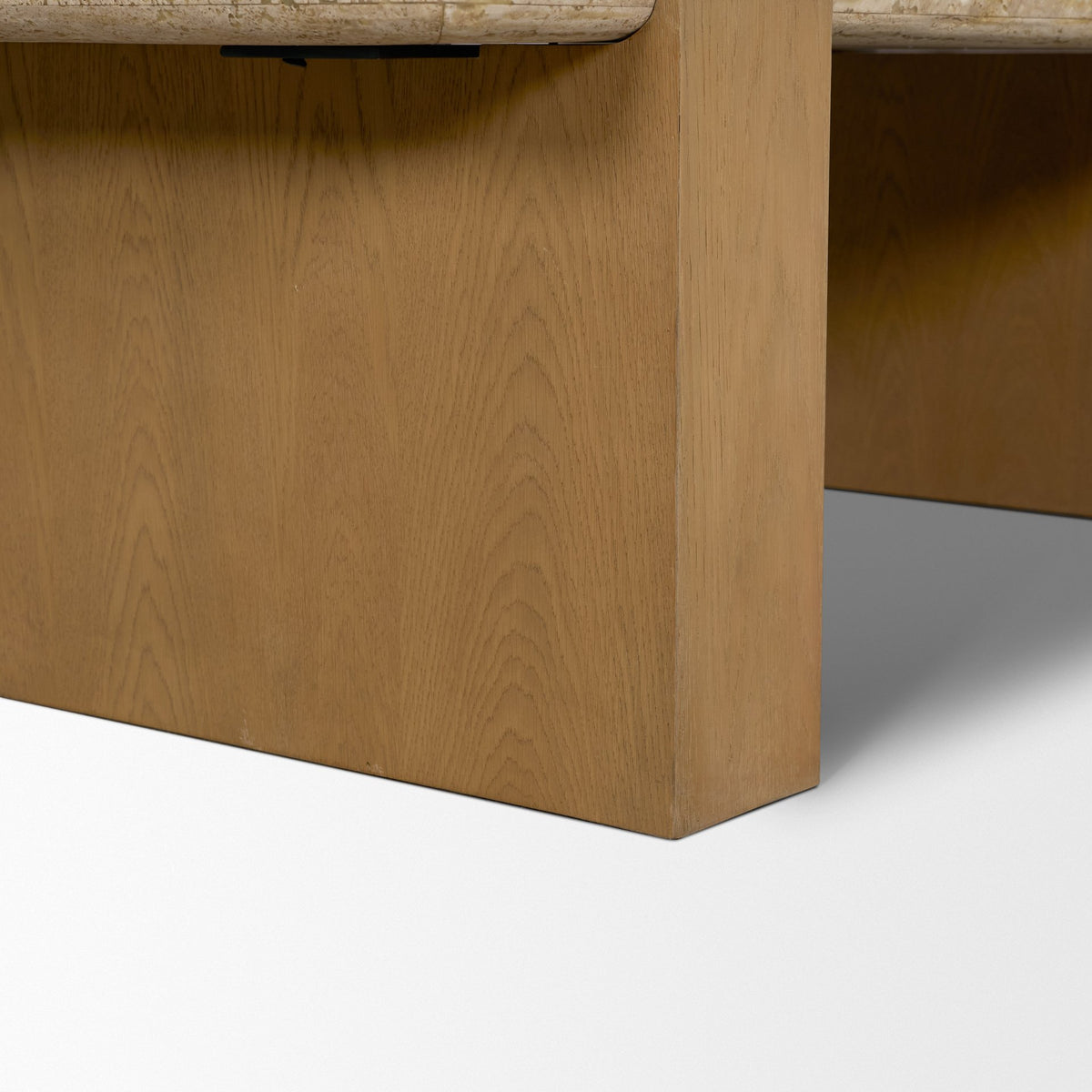 Close-up of the Cavelle Coffee Table solid oak blade leg with visible natural grain and warm light brown finish.