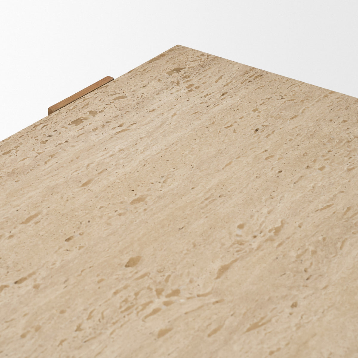 Close-up of the Cavelle Coffee Table top showing the natural pores and warm tonal variation of genuine beige travertine.