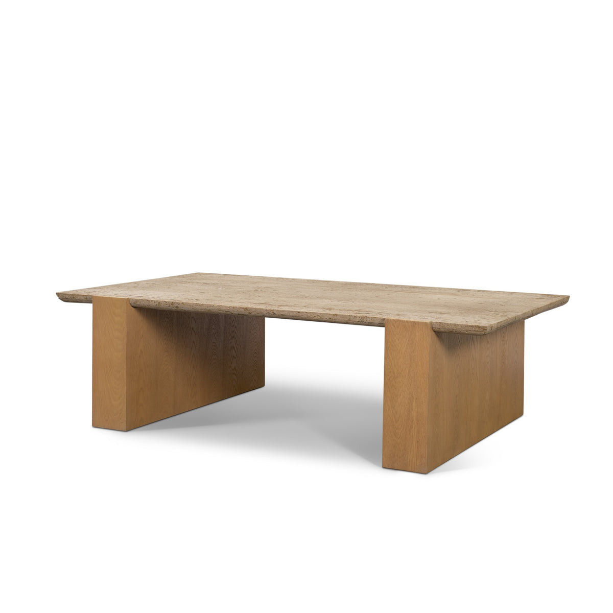 Angled view of the Cavelle Travertine & Oak Coffee Table showing the rectangular travertine top and two solid oak blade legs.