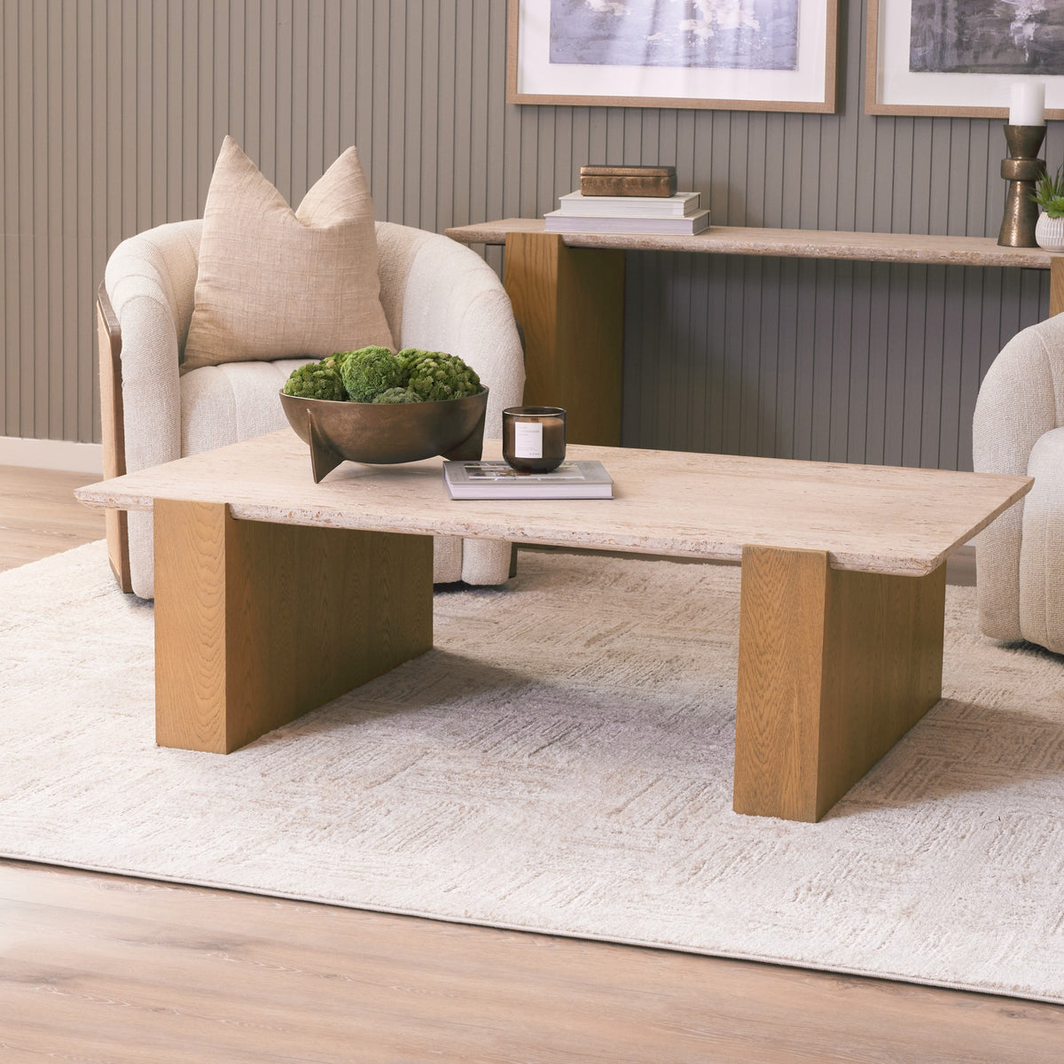 Cavelle Travertine & Oak Coffee Table styled in a warm contemporary living room with two lounge chairs.