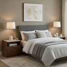 The Celine lamp set styled on walnut nightstands flanking a grey upholstered bed for an elegant bedroom lighting setup.
