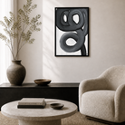 Modern living room with abstract art, vase, and armchair.