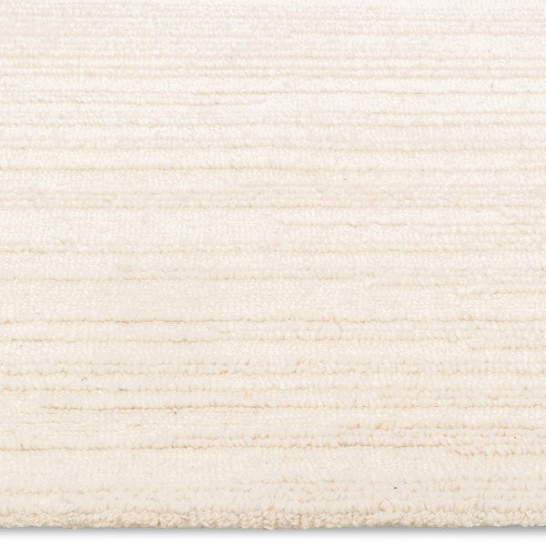 A close-up of the Claire Hand-tufted Rug with subtle textures and a soft, plush surface.