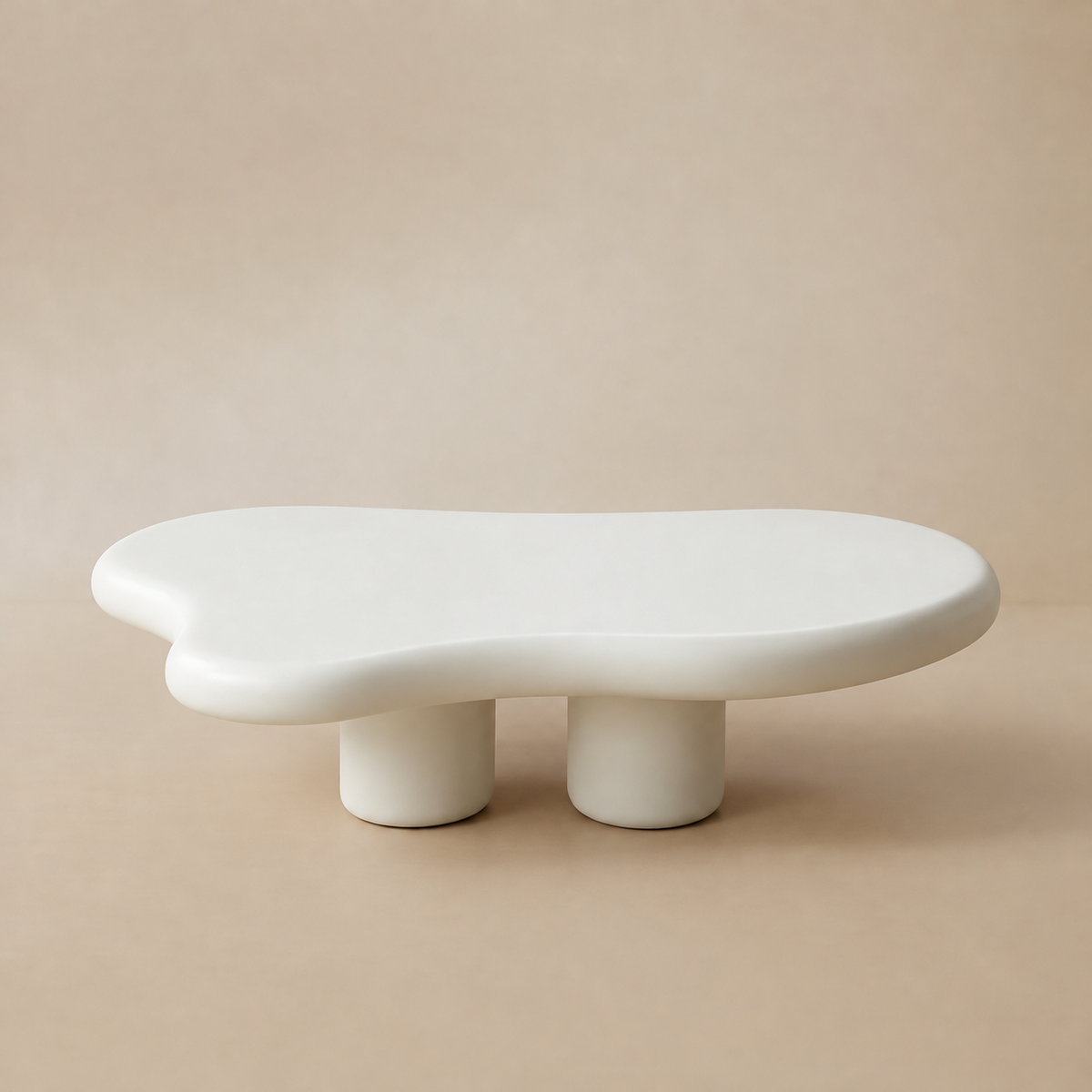 Cloud Shape Coffee Table with smooth sculptural design in matte white finish styled in a beige studio