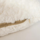 Close-up of the curly-pile lumbar pillow from the Cloudline set showing the hidden zipper and plush texture.