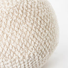 Macro close-up of the spherical Cloudline pillow showcasing its unique chunky honeycomb bouclé weave.