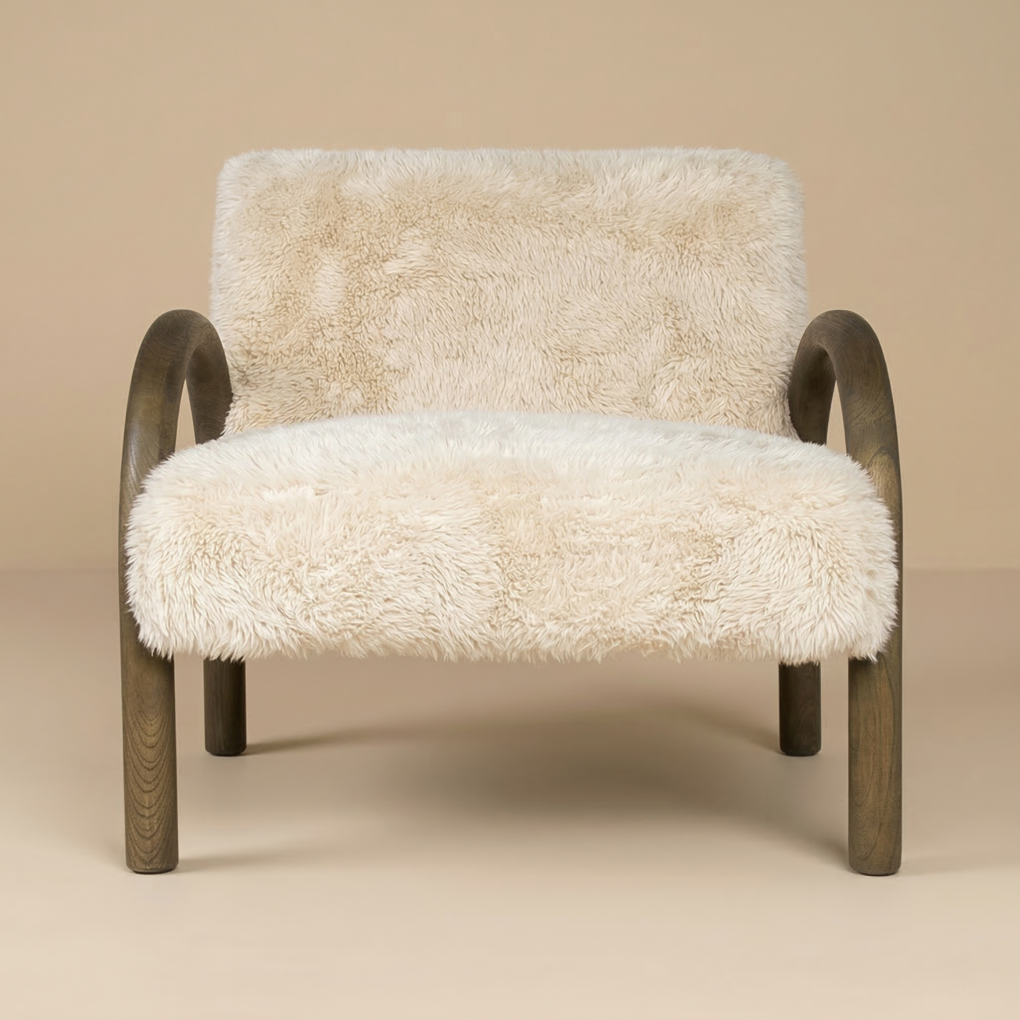 Full front view of the Coco accent chair featuring shaggy sand faux fur and arched dark wood arms.