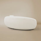 Side view of the Contour Bliss Boucle Sofa in a beige background