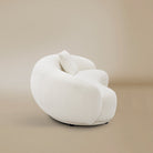 Side view of the Contour Bliss Boucle Sofa on a beige background