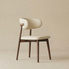 Angled view of the Modern Leather Ash Wood Dining Chair highlighting the unique wrap-around backrest and tapered wooden legs.