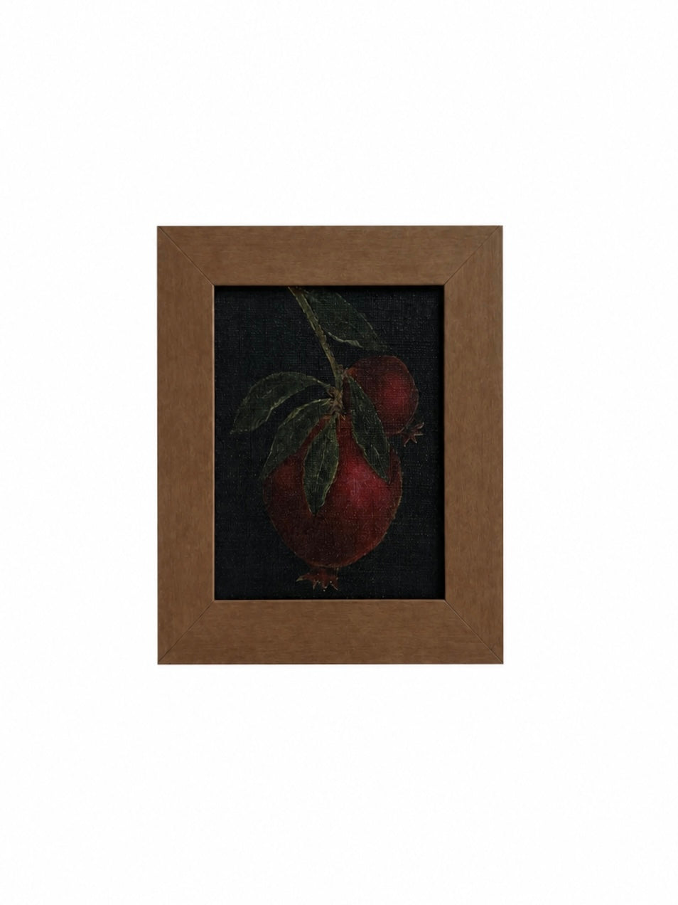 Framed artwork of a pomegranate on a dark background
