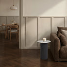Living room with a sofa, side table, and candle