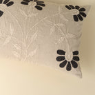 Decorative pillow with floral embroidery on a beige background