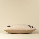 Decorative pillow with floral embroidery on a beige background