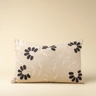 Decorative pillow with floral embroidery on a beige background