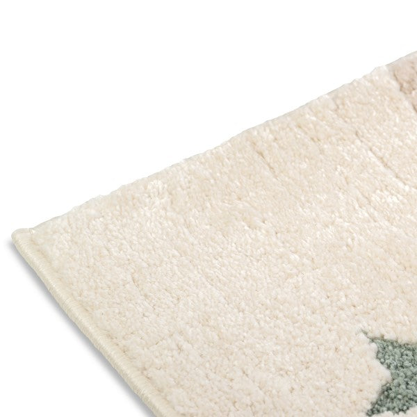 Close-up corner detail of the Dreamy Arc Kids Rug showing its soft ivory pile.