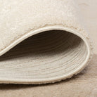 Folded edge detail of the Dreamy Arc Kids Rug showing its bound edge and woven backing.