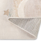 Folded corner of the Dreamy Arc Kids Rug showing part of the pastel rainbow design and backing.