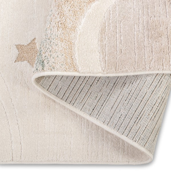 Folded corner of the Dreamy Arc Kids Rug showing part of the pastel rainbow design and backing.